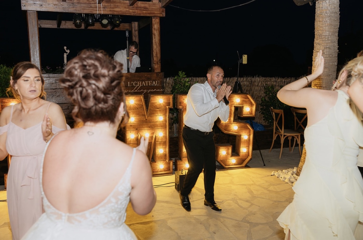 A joyful wedding party with James on the microphone